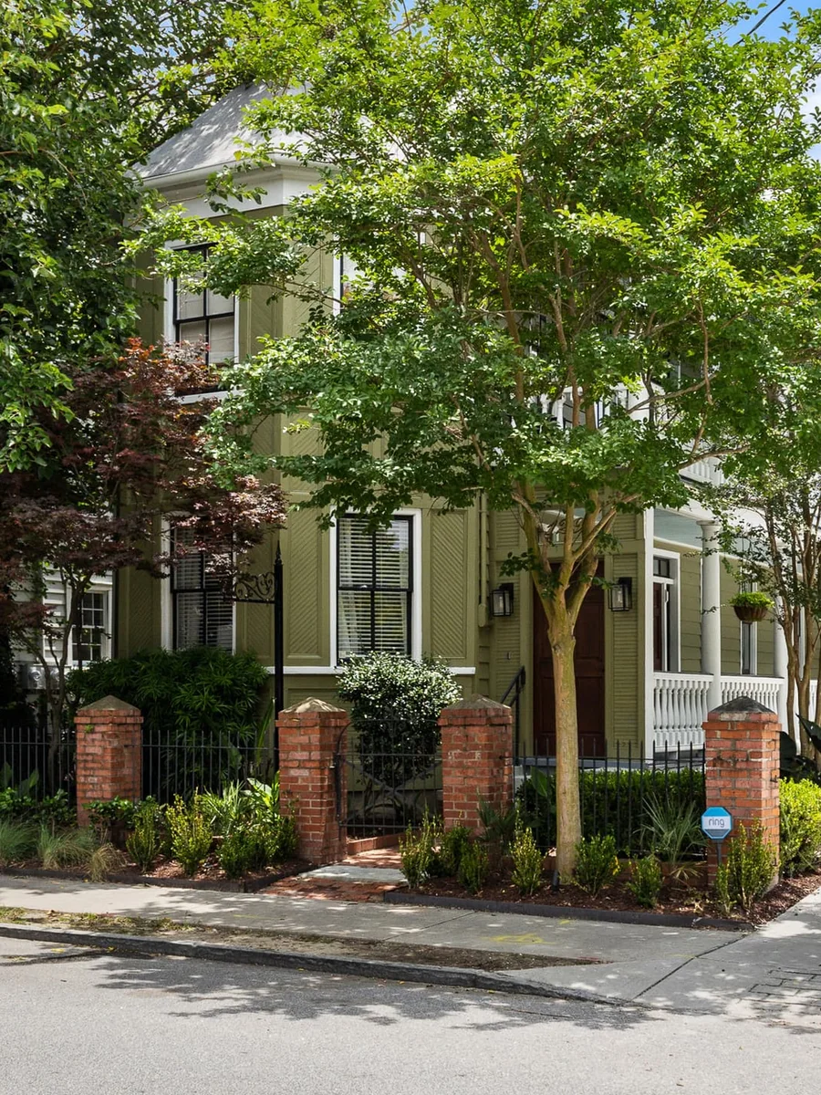 The green facade and garden gate of The Mint Julep Residence on Cannon Street